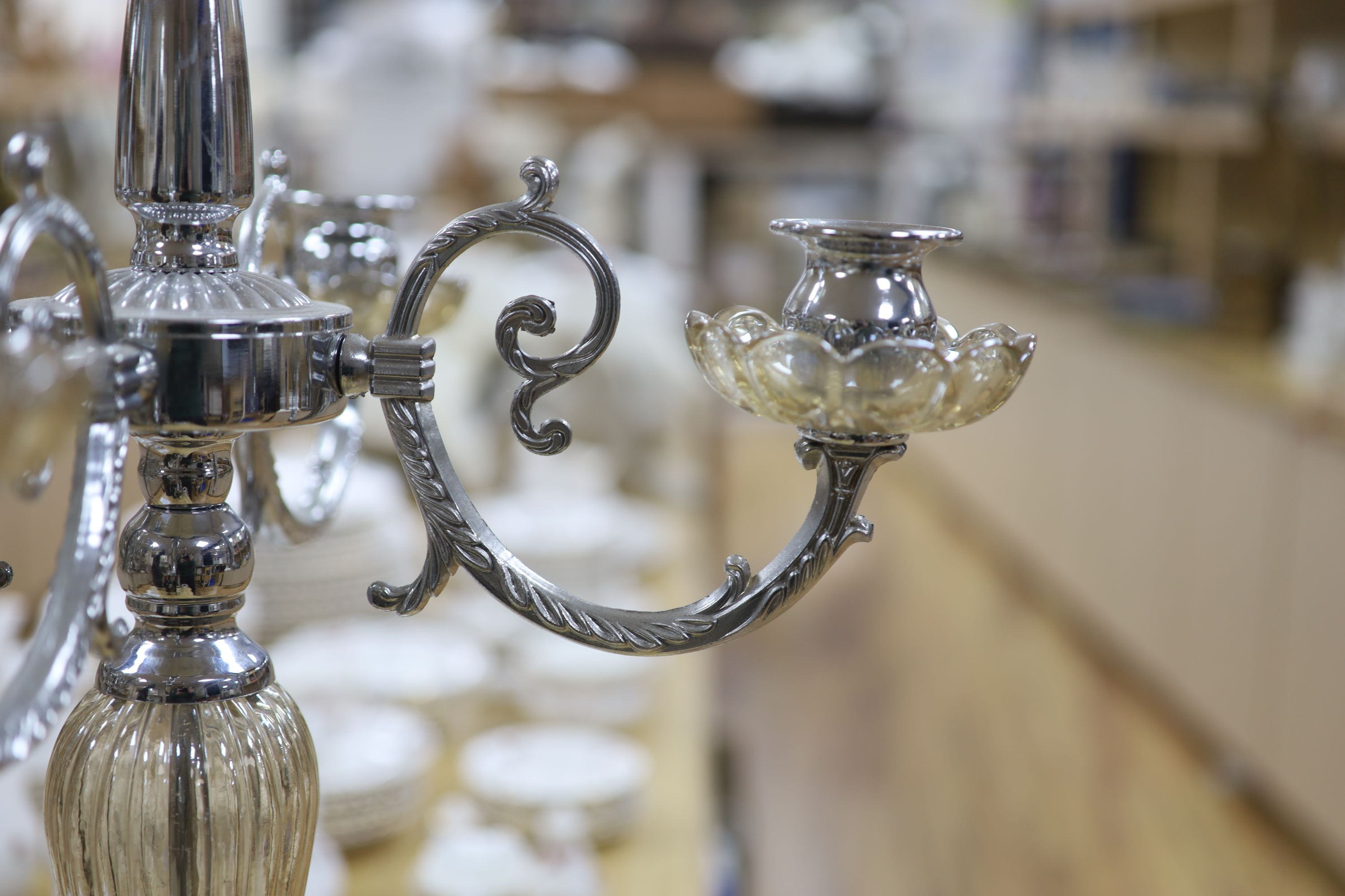 A pair of plated and glass four branch five light candelabra, height 68cm